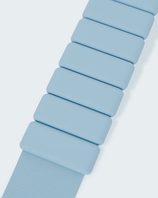 Close-up of the Vibrant Bangles Set shows light blue segments with rectangular links. Each link has smooth edges and a matte finish, set against a plain, light background that emphasizes the band's color and texture.