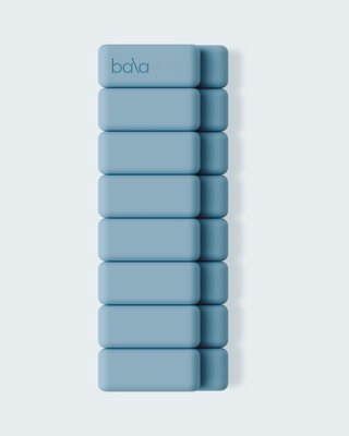 Nine vertically aligned, rounded-edge, blue rectangular blocks form a stack with "bala" on the top one. Set against a light gray backdrop for contrast, this artistic layout mesmerizes like the Vibrant Bangles Set for an Energizing Look.