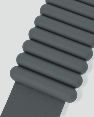 The Vibrant Bangles Set features a modern design with horizontally aligned, rounded dark teal bars stacked symmetrically in two rows for a rippled effect. Below, a textured dark teal strip contrasts beautifully against the smooth bars and light background.