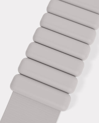 A close-up of the Vibrant Bangles Set, showcasing white segmented bangles with rectangular links and smooth curves. The sleek, modern matte finish on a plain white background offers a minimalist aesthetic.