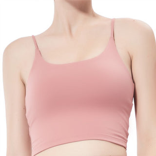 A person in a light pink Camisole Sports Top with spaghetti straps, cropped at the shoulders and waist, against a plain white background. The smooth, fitted fabric emphasizes the top's simplicity and casual style.