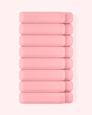 A neatly stacked set of ten pink rectangular Vibrant Bangles for an Energizing Look with rounded edges on a white background. The top bangle has the word "bala" embossed. They are uniform in size and aligned in two columns.
